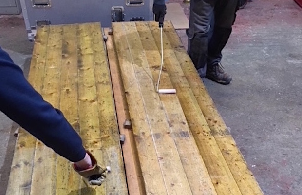 Varnishing every marquee floorboard by hand