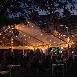 Outdoor party marquee with festoon lighting in Arran