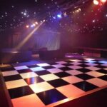 Wedding Marquee with black star cloth ceiling, dance floor and event lighting