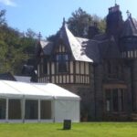 Wedding marquee in a country house setting with window walls