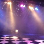Party Marquee with black star cloth ceiling and event lighting and dance floor