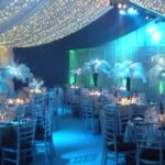 Party Marquee with ivory star cloth ceiling and event lighting, dance floor and table decorations