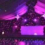 Marquee decorated for a party setting with DJ Booth