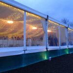 Panoramic windows showing the pea lamp roof canopy within the marquee