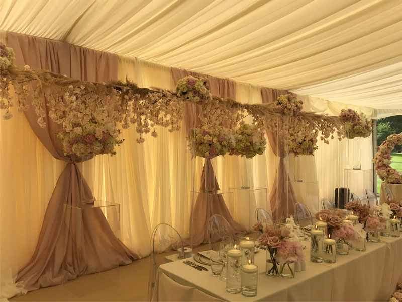 Wedding Marquee with the top table, chairs and floral decorations