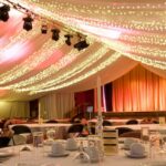 Party Marquee with ivory star cloth ceiling and event lighting and table decorations - marquee photo galleries - Tents and Events