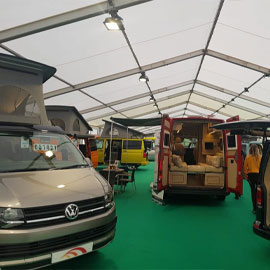 Green carpeted marquee with campervans for the Scottish Caravan, Motorhome and Holiday Home Exhibition at the SECC in Glasgow