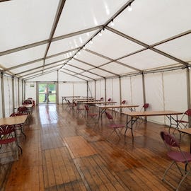 Marquee for Emergency Use - staff welfare area in the work place to allow for social distancing. The marquee is furnished with trestle tables and chairs for staff.
