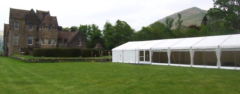 Wedding marquee with panoramic window walls in grounds of Ardkinglas historic house.