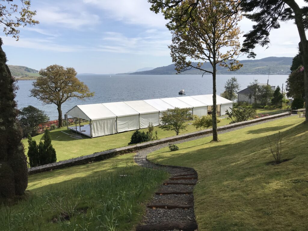Build of a wedding marquee in a private garden in Argyll showing the roof and back walls
