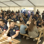 Our Hampden FanZone for a Scotland vs England football match filled with picnic benches full of fans