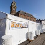 The Kist marquee secured by covered water ballast barrels at Wigtown Book Festival