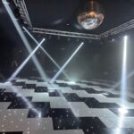Entertainment lighting truss with starcloth roof and gable over an LED dancefloor