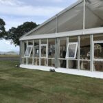 Wedding marquee on the shores of Loch Lomond with opening solid glazed windows and a clear gable