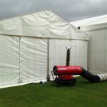 Thermobile heater blowing warm air through ducting into a wedding marquee